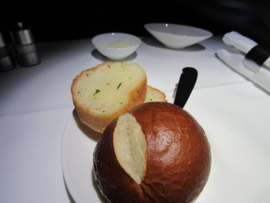 a bread roll and a knife on a plate