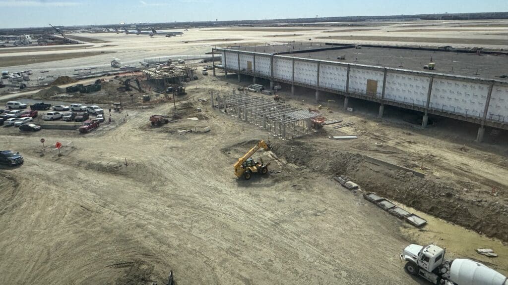 a construction site with a large building and a large truck