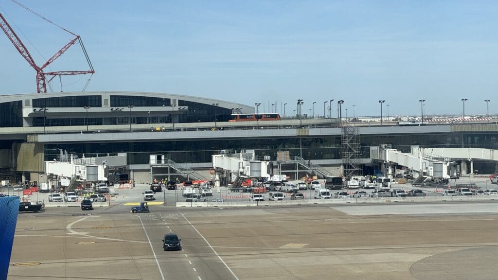 a large airport with cars and trucks