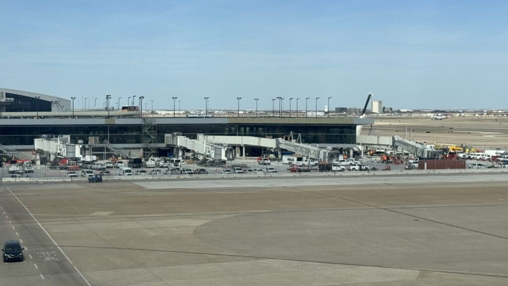 an airport with a building and a runway