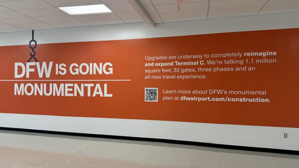a large orange and white sign on a wall