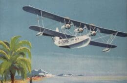 an airplane flying over a beach