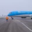a blue airplane on a runway