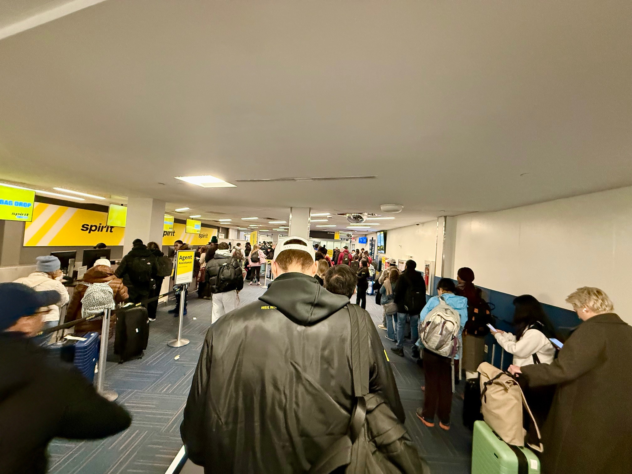 a group of people in a hallway with luggage