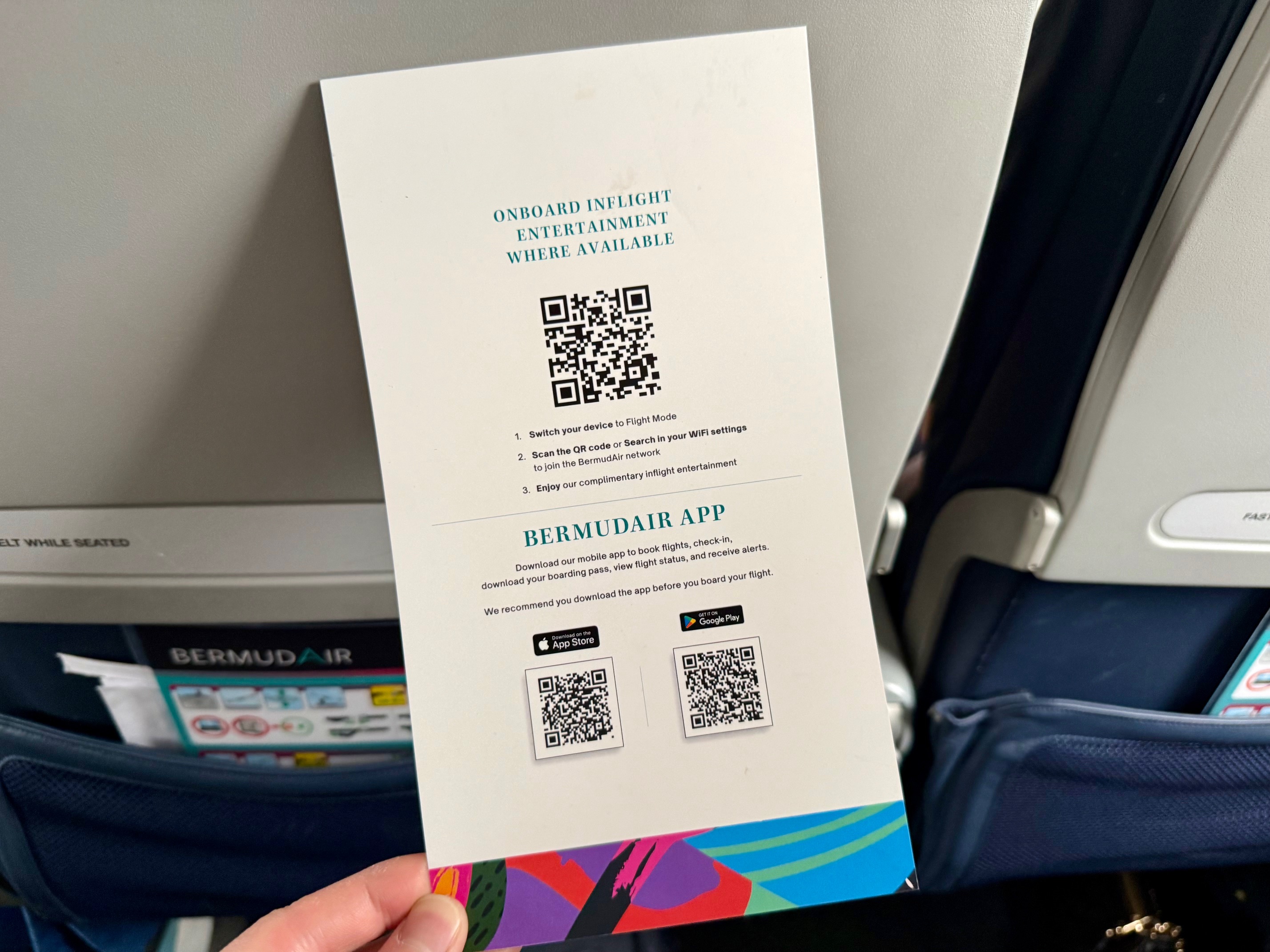 a hand holding a paper with qr code