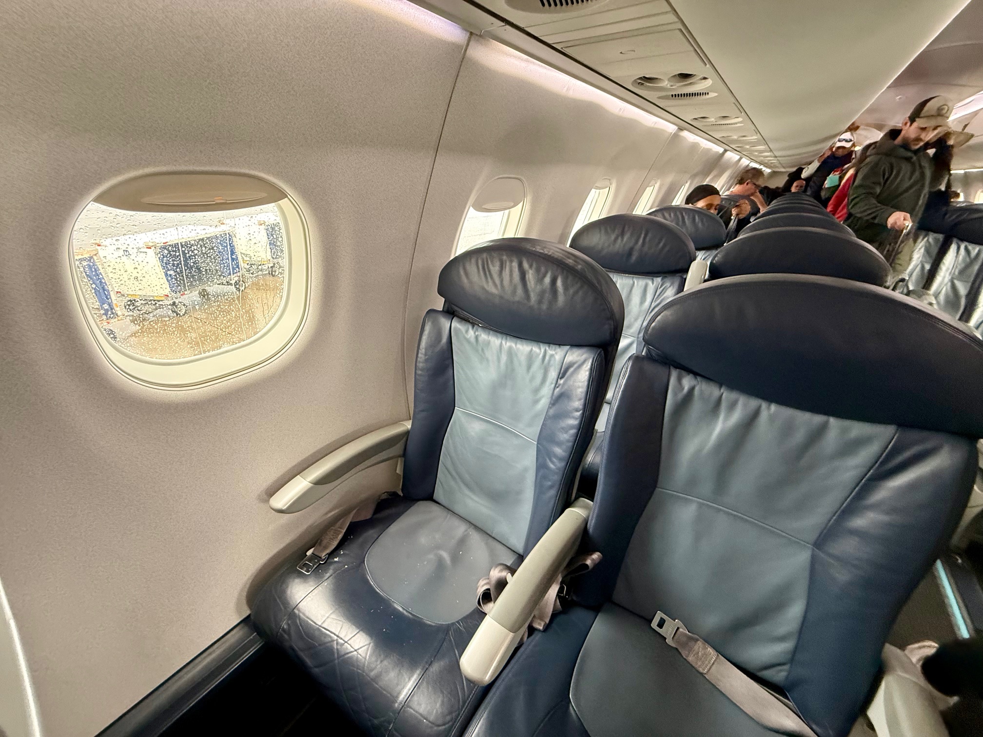 a row of seats on BermudAir E175 Economy Cabin