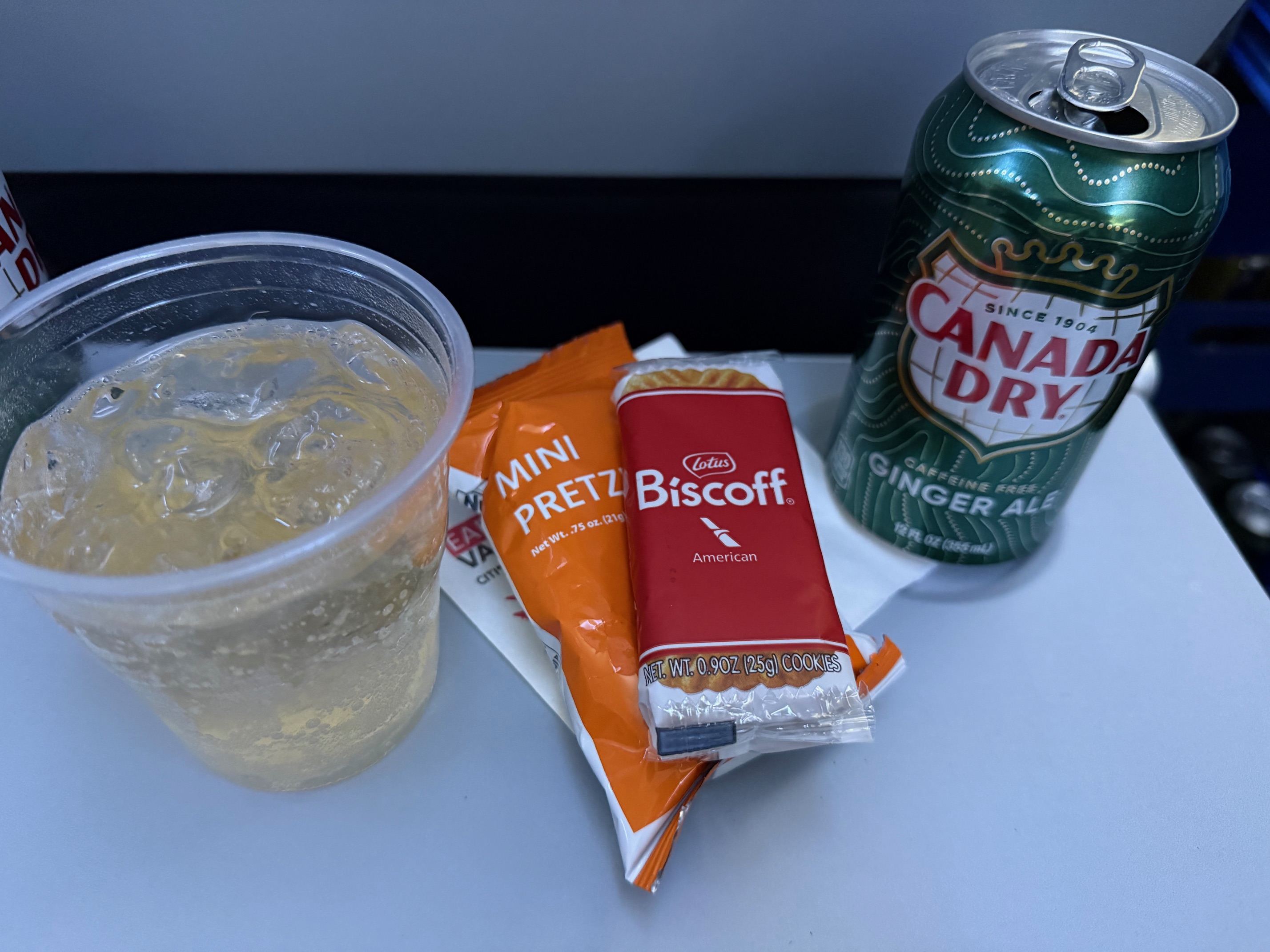 a drink on a table aboard American Airlines 737 MAX 8