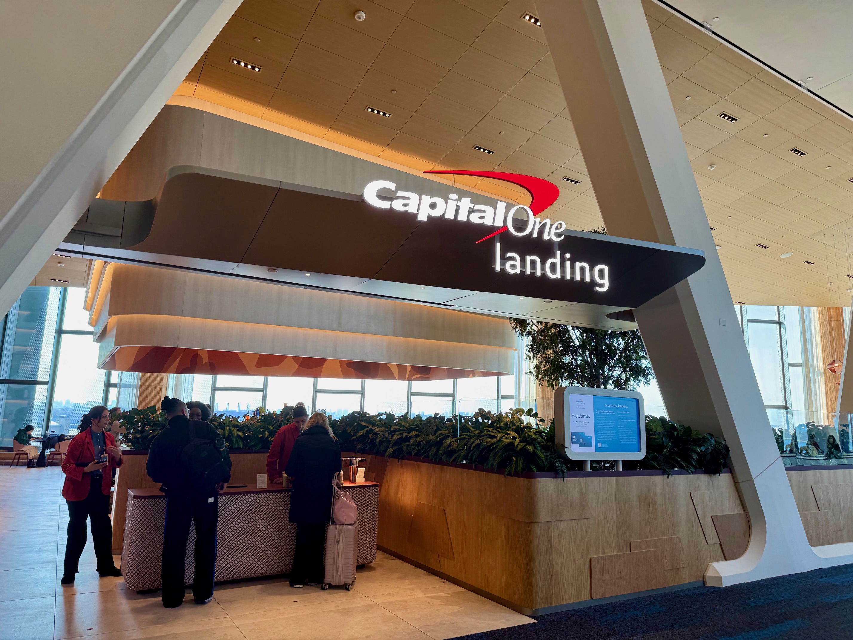 a group of people standing in front of a sign