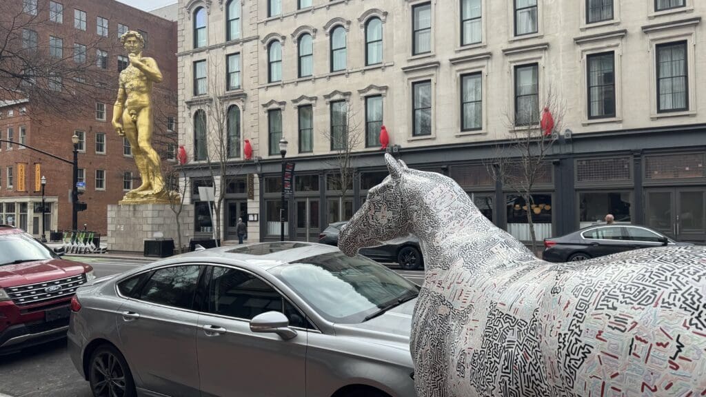 a statue of a horse in a city