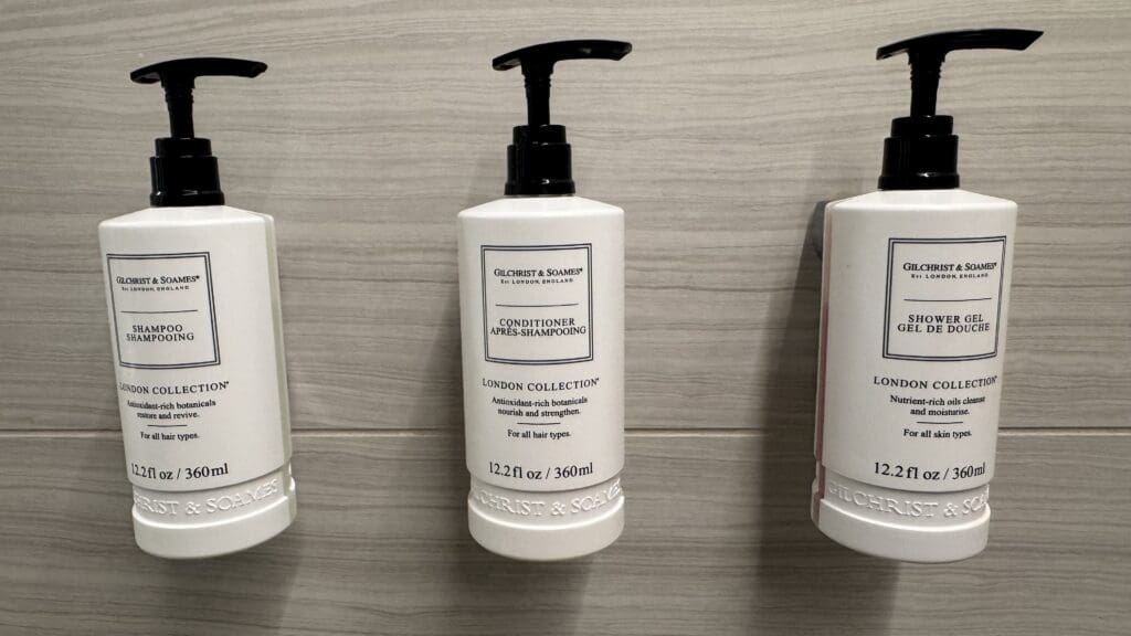 a group of white bottles with black lids