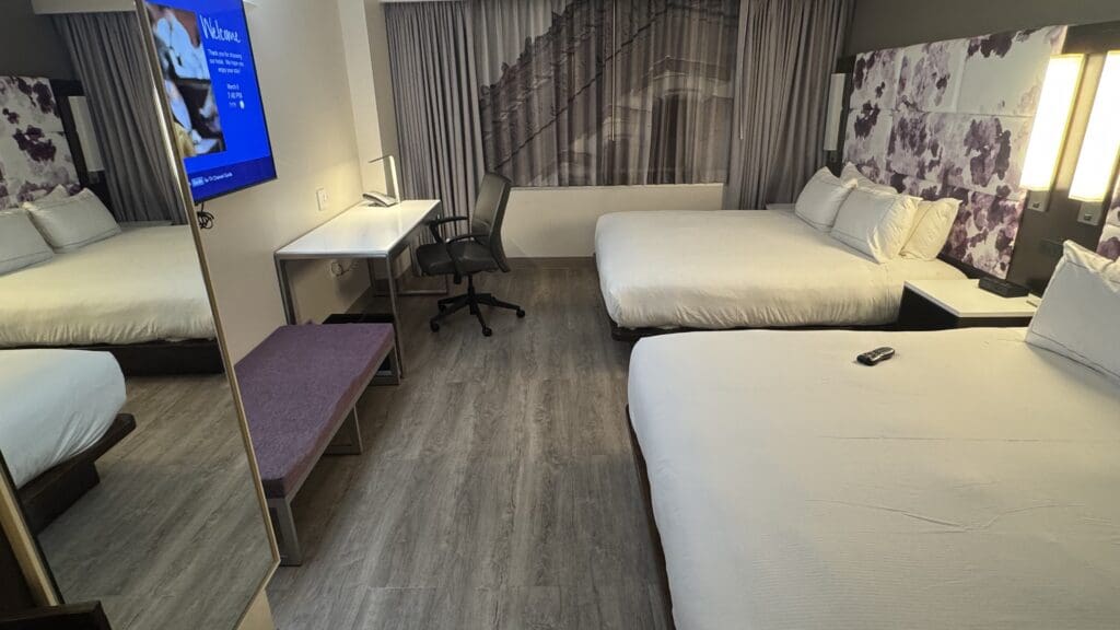 a room with two beds and a desk