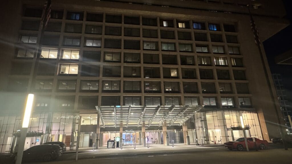 a building with glass windows and a parking lot