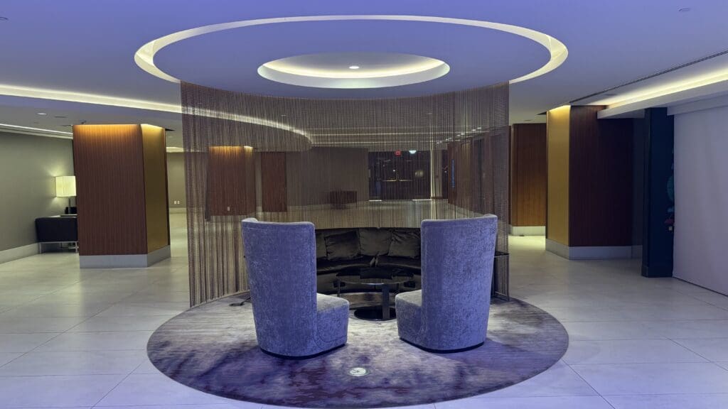 a room with a round area with chairs and a round table