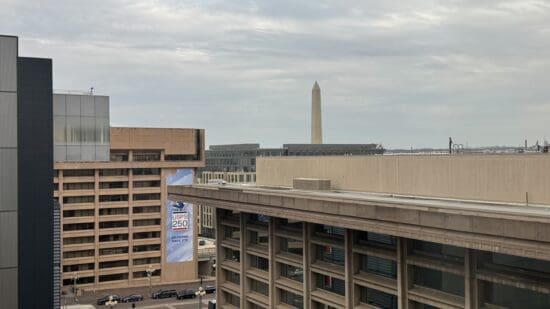 a building with a tall monument in the background