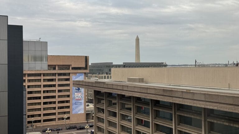 a building with a tall monument in the background